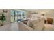Living room with large windows, comfortable seating, and a coffee table at 134 Da Vinci Dr, Nokomis, FL 34275