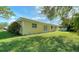 Large backyard with green grass and trees at 134 Da Vinci Dr, Nokomis, FL 34275