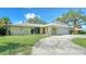 Front view of a single-story house with a curved driveway at 134 Da Vinci Dr, Nokomis, FL 34275