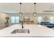 Kitchen island with sink and breakfast bar seating at 14132 Campfire Ct, Parrish, FL 34219