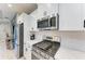 Modern kitchen features stainless steel gas range and microwave at 14132 Campfire Ct, Parrish, FL 34219