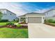 Newly built home with gray exterior, landscaping, and two-car garage at 14132 Campfire Ct, Parrish, FL 34219