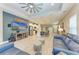 Open concept living area with kitchen and large TV at 14132 Campfire Ct, Parrish, FL 34219