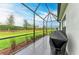 Screened patio with built-in grill and backyard access at 14132 Campfire Ct, Parrish, FL 34219