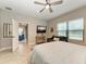 Main bedroom with a king-size bed and sitting area at 14132 Campfire Ct, Parrish, FL 34219