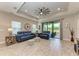Spacious living area with blue couches and wood-look tile floors at 14132 Campfire Ct, Parrish, FL 34219