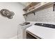 Laundry room with Samsung washer and dryer, and decorative shelving at 14132 Campfire Ct, Parrish, FL 34219
