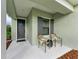 Inviting front porch with gray door and two chairs at 14132 Campfire Ct, Parrish, FL 34219