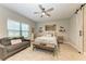 Bedroom with queen bed, gray couch, and barn door at 14132 Campfire Ct, Parrish, FL 34219