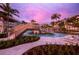 Lazy river pool with bridge and lounge chairs at 1581 Gulf Of Mexico Drive # 407, Longboat Key, FL 34228