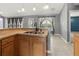 Modern kitchen with double sink, light wood cabinets, and breakfast bar at 1661 Atwater Dr, North Port, FL 34288