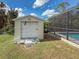 White storage shed with roll-up door at 1661 Atwater Dr, North Port, FL 34288
