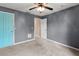 Bedroom with ceiling fan and teal door at 1661 Atwater Dr, North Port, FL 34288