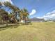 Spacious backyard with grassy area and palm trees at 1661 Atwater Dr, North Port, FL 34288