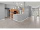 Open kitchen with light wood cabinets, neutral countertops, and tile floors at 1661 Atwater Dr, North Port, FL 34288