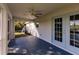 Covered screened patio with ceiling fan and light blue French doors at 2415 Ancient Rd, North Port, FL 34286