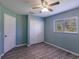 Light blue bedroom with double door closet and window at 2415 Ancient Rd, North Port, FL 34286