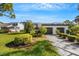 Front view of two-story townhome with attached two-car garage and landscaped yard at 3119 Heatherwood Ln, Sarasota, FL 34235