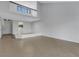 Open living area with tile floors, high ceilings, and loft area with railing at 3119 Heatherwood Ln, Sarasota, FL 34235