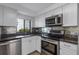 Modern kitchen with stainless steel appliances and granite countertops at 3119 Heatherwood Ln, Sarasota, FL 34235
