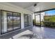Spacious screened patio with tiled floor and view of garden at 3119 Heatherwood Ln, Sarasota, FL 34235