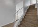 Staircase with tile flooring and white railing at 3119 Heatherwood Ln, Sarasota, FL 34235