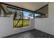 Screened porch with tile flooring and a view of the golf course at 3119 Heatherwood Ln, Sarasota, FL 34235