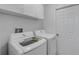 Laundry room with washer, dryer, and overhead cabinets at 3119 Heatherwood Ln, Sarasota, FL 34235