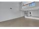 Open living area with tile floors, high ceilings, and loft area with railing at 3119 Heatherwood Ln, Sarasota, FL 34235