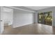 Living room with tile floor, sliding glass doors, and access to loft area at 3119 Heatherwood Ln, Sarasota, FL 34235