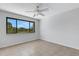 Bright bedroom with tile floors and large window offering a view at 3119 Heatherwood Ln, Sarasota, FL 34235