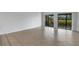 Bright living room with tile floors and sliding glass doors leading to a view at 3119 Heatherwood Ln, Sarasota, FL 34235