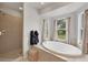 Bright bathroom featuring a soaking tub with windows and a separate tiled shower at 38603 Taylor Rd, Myakka City, FL 34251