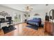 Spacious bedroom with wood floors, ceiling fan, and a French door leading to the outdoors at 38603 Taylor Rd, Myakka City, FL 34251