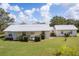 Charming single-story home with a well-maintained lawn, metal roof, and inviting front porch at 38603 Taylor Rd, Myakka City, FL 34251
