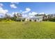 Spacious front yard showcasing a well-manicured lawn and a charming one story home at 38603 Taylor Rd, Myakka City, FL 34251