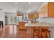 Well-lit kitchen features light wooden cabinets, an island with seating, and modern appliances at 38603 Taylor Rd, Myakka City, FL 34251