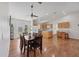 Open floor plan with dining area, wood floors, and natural light flowing from the sliding glass doors at 38603 Taylor Rd, Myakka City, FL 34251