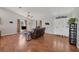 Cozy living room with hardwood floors, neutral tones, and decorative accents at 38603 Taylor Rd, Myakka City, FL 34251