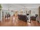 Open-concept living space showcasing hardwood floors, a comfortable seating area, and a seamless flow to the kitchen at 38603 Taylor Rd, Myakka City, FL 34251