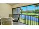 Screened patio with table and chairs overlooking golf course at 4416 Weybridge # 90, Sarasota, FL 34235