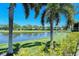 Peaceful pond-side view with lush landscaping and homes in the background at 4416 Weybridge # 90, Sarasota, FL 34235