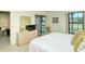 Bedroom with dresser, TV, and access to private balcony at 4416 Weybridge # 90, Sarasota, FL 34235