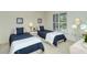 Guest bedroom with two twin beds and ample closet space at 4416 Weybridge # 90, Sarasota, FL 34235