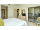 Comfortable bedroom with access to a patio and en-suite bathroom at 4416 Weybridge # 90, Sarasota, FL 34235