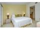 King-size bed, updated nightstands, and en-suite bathroom at 4416 Weybridge # 90, Sarasota, FL 34235