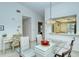 Dining area with glass table, view of kitchen and hallway at 4416 Weybridge # 90, Sarasota, FL 34235