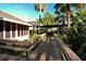 Wooden walkway through lush tropical landscaping at 4416 Weybridge # 90, Sarasota, FL 34235