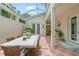 Covered patio with dining table and grill at 4561 Murcia Blvd # 13, Sarasota, FL 34238