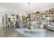 Open living space with a large built-in shelving unit and access to the kitchen at 4561 Murcia Blvd # 13, Sarasota, FL 34238